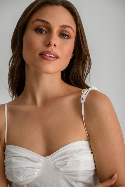 Top with thin straps tie and peplum hem