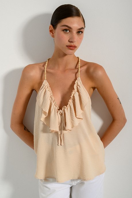 Top with frilled details and beads on the straps