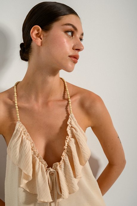 Top with frilled details and beads on the straps